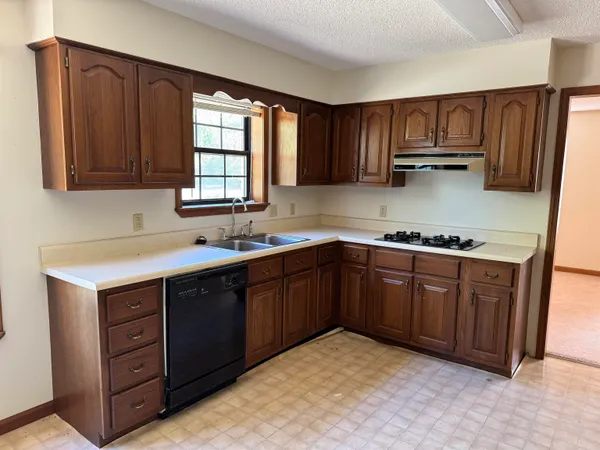 a kitchen with sink cabinets and window
