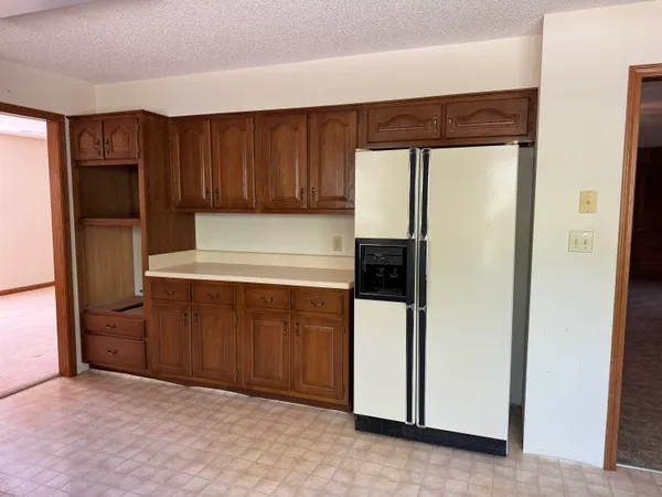 a kitchen with cabinets and a refrigerator
