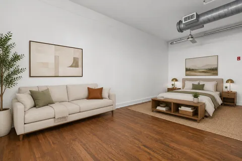 a bedroom with a bed and a couch