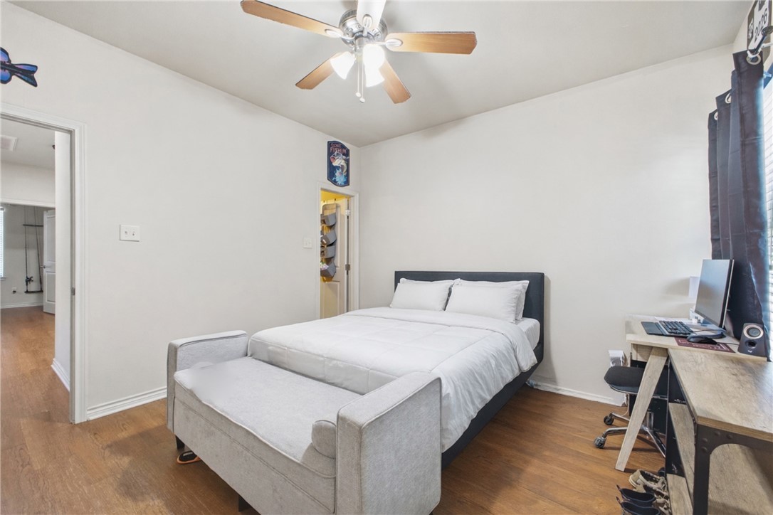 4400 Milam Street Bryan, TX 77801 - Photo 16 of 25 a bedroom with a bed and a chandelier