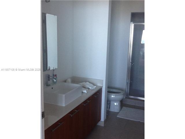 3301 Northeast 1st Avenue, Unit 2604H Miami, FL 33137 - Photo 4 of 8 a bathroom with a toilet a sink and mirror