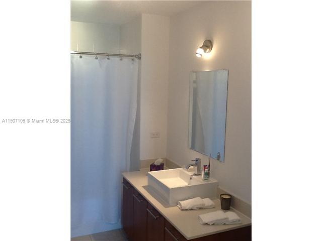 3301 Northeast 1st Avenue, Unit 2604H Miami, FL 33137 - Photo 5 of 8 a bathroom with a sink and a mirror