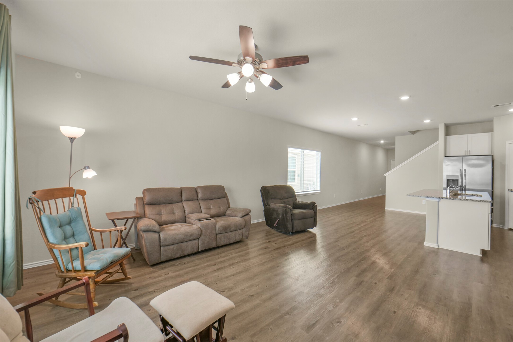 21610 Desert Lilly Road Waller, TX 77484 - Photo 5 of 36 Spacious open-concept living area with Luxury Vinyl flooring, ceiling fan, and natural light. Ideal for comfortable living and entertaining.