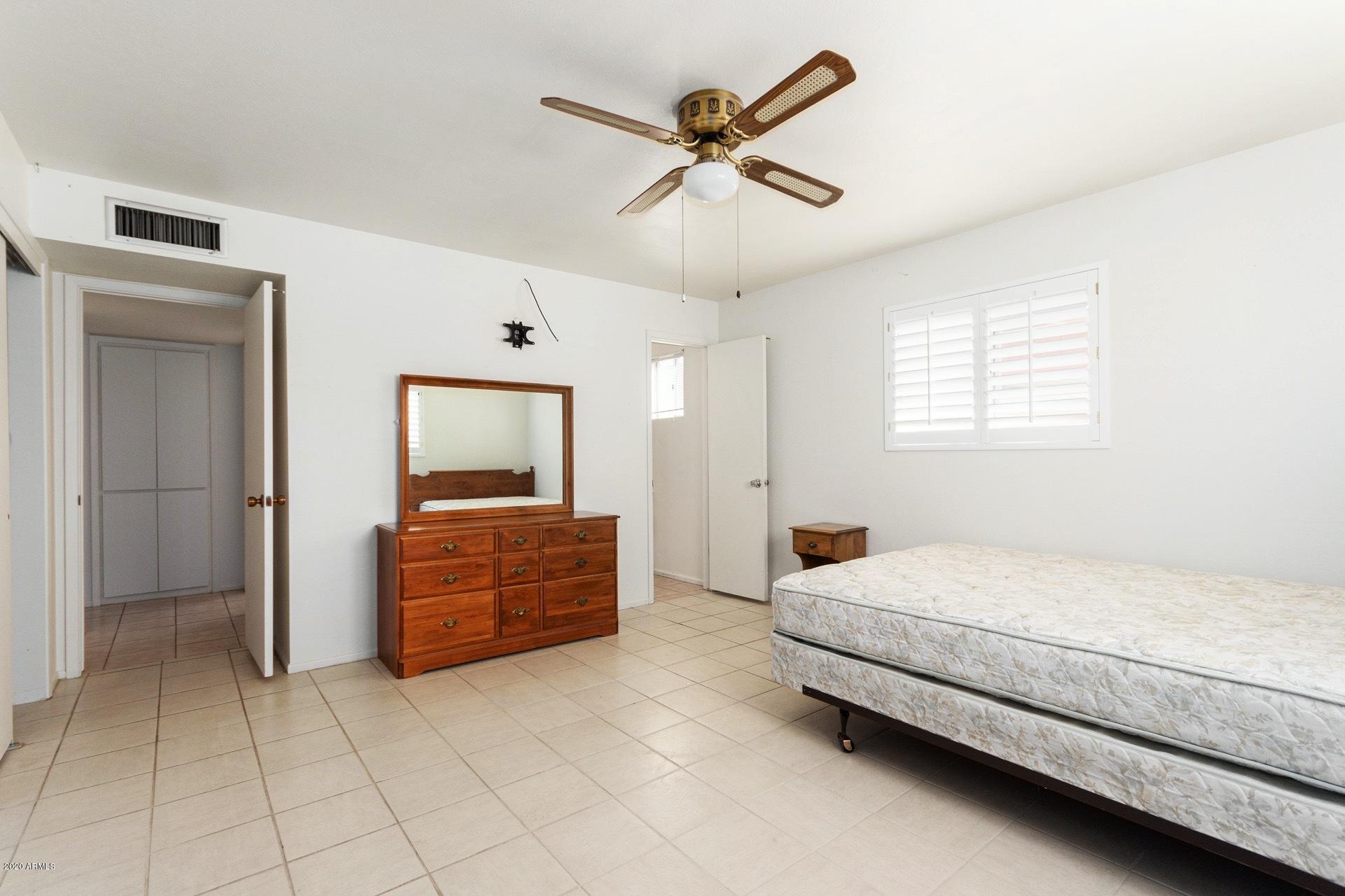5704 East Decatur Street Mesa, AZ 85205 - Photo 32 of 40 a bedroom with a bed and a dresser