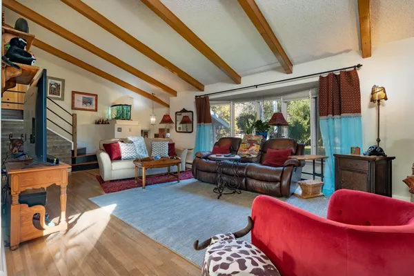 a living room with furniture a rug and a large window