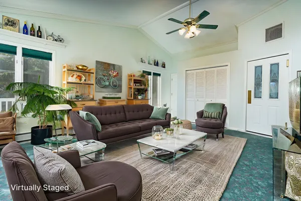 a living room with furniture and a chandelier