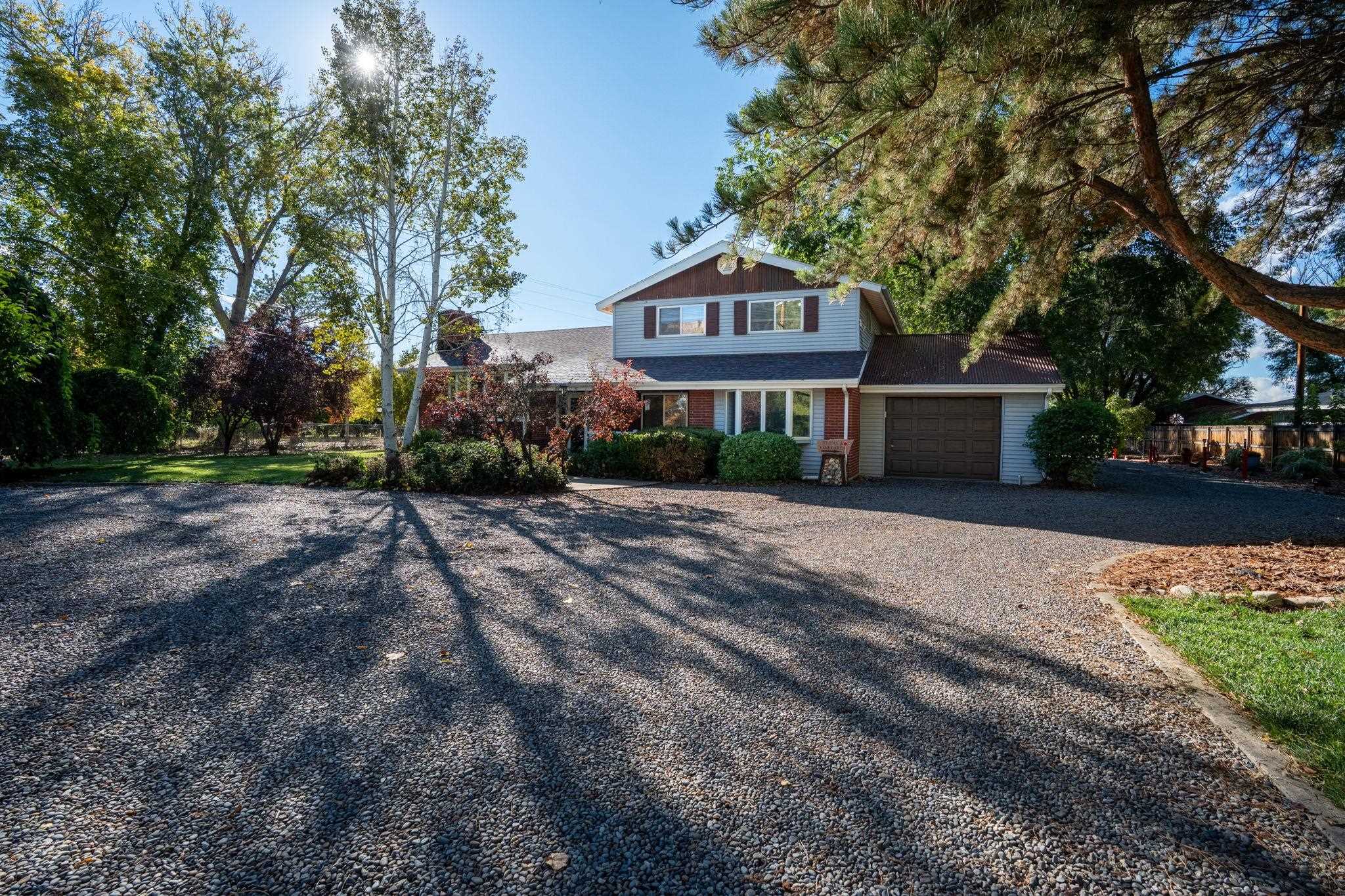 3587 G Road Palisade, CO 81526 - Photo 2 of 42 a front view of a house with a yard and garage