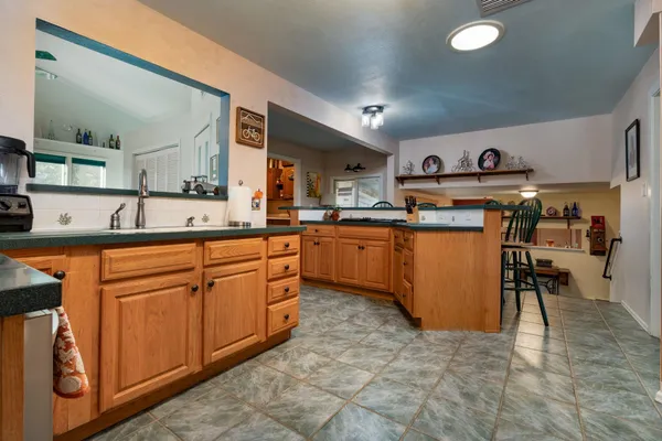 a kitchen with cabinets a sink and appliances