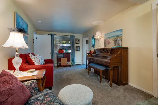 a living room with furniture and a lamp