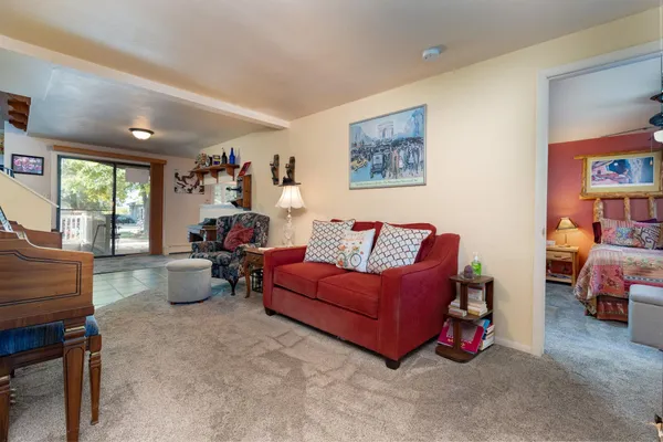 a living room with furniture and a book shelf