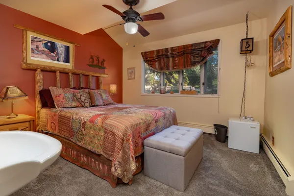 a bedroom with a bed and a chandelier