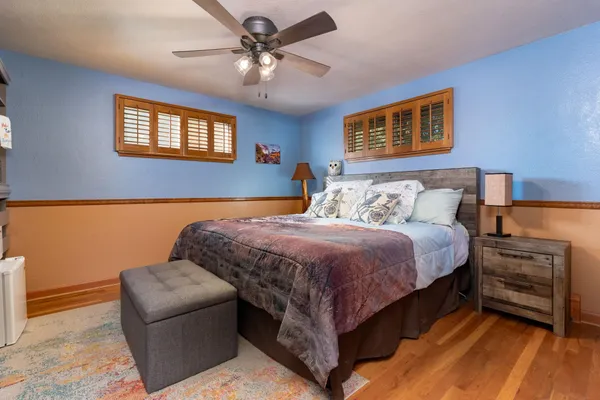 a bedroom with a bed and a chandelier