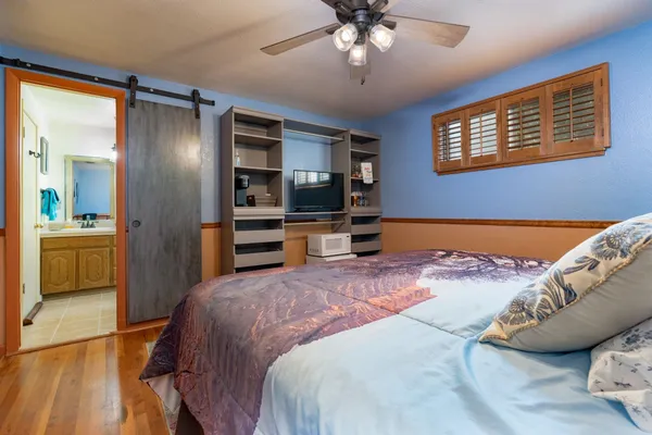 a bedroom with a bed and a chandelier