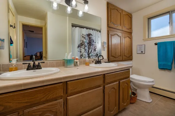 a bathroom with a toilet sink and mirror