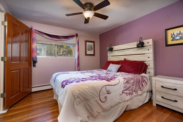 a bedroom with a bed and a window