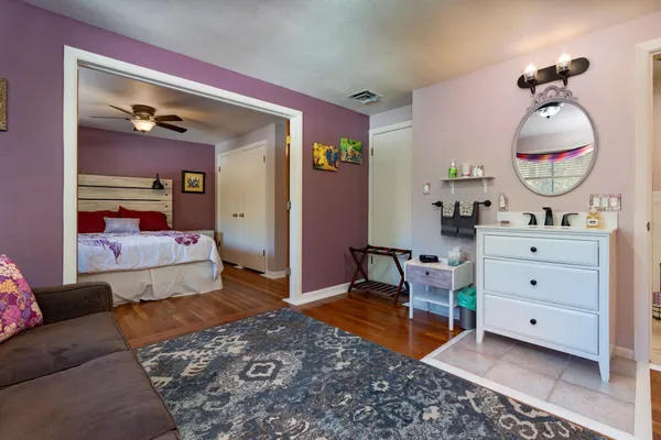 a bedroom with a bed and wooden floor