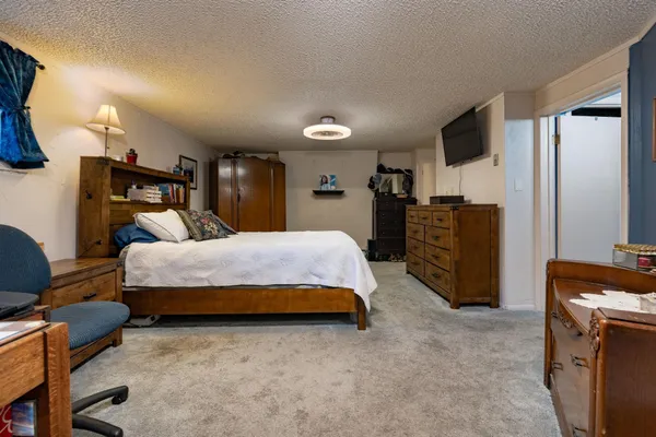 a spacious bedroom with a bed and furniture