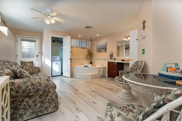 a living room with furniture and kitchen view