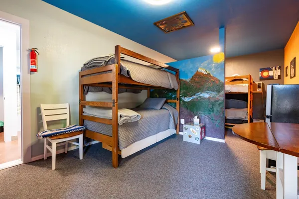 a bedroom with furniture and a lamp
