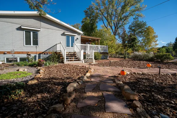 a view of backyard with outdoor seating and green space