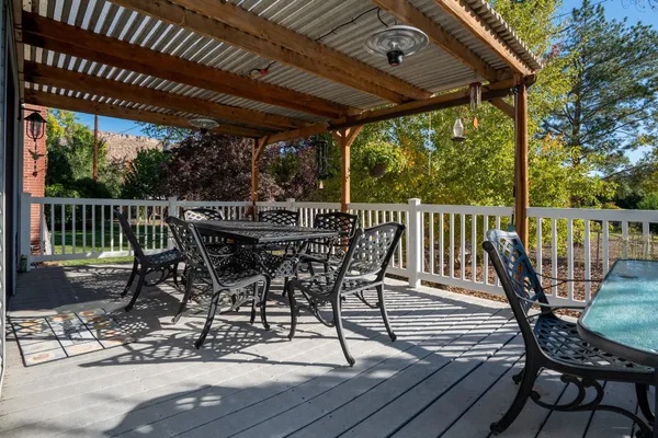 a view of a patio with a table chairs and backyard