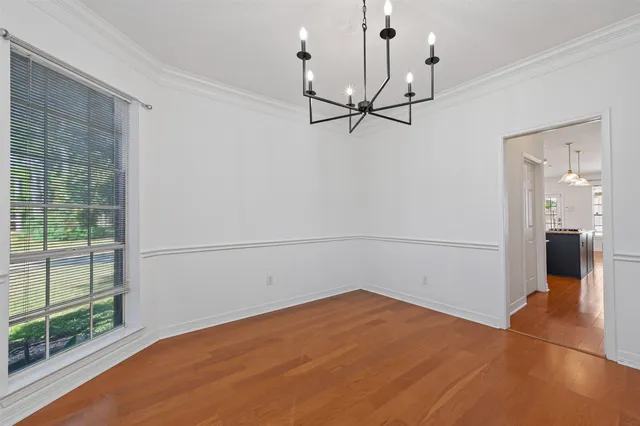 a kitchen with stainless steel appliances granite countertop a refrigerator a oven and a sink with wooden floor