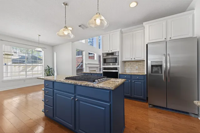 a bathroom with a toilet a sink a mirror a bathtub and vanity