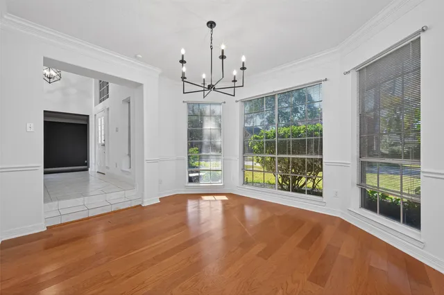a view of empty room with stairs and a rug