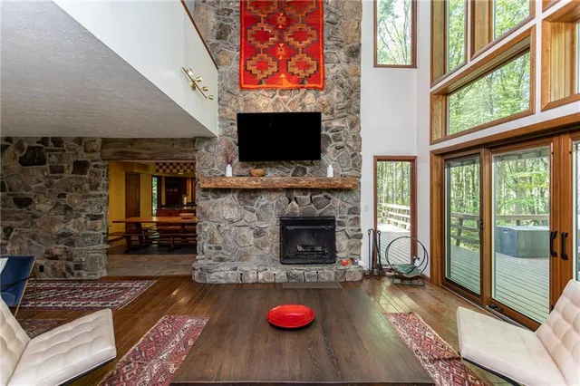 a living room with furniture a flat screen tv and a fireplace