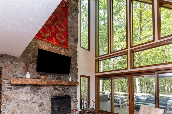 a living room with a fireplace and a flat screen tv