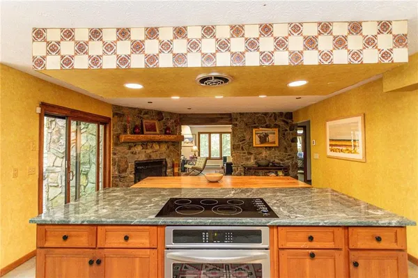 a kitchen with stainless steel appliances granite countertop a sink and wooden cabinets