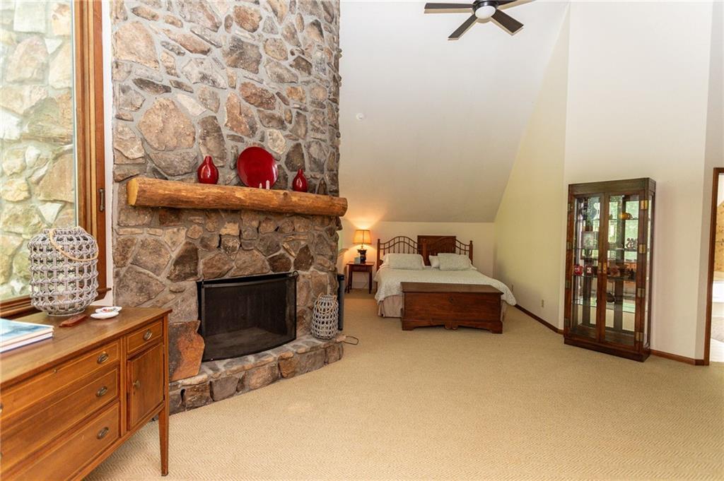 255 Smith School Road Farmington, PA 15437 - Photo 31 of 50 a bedroom with a bed and a fireplace