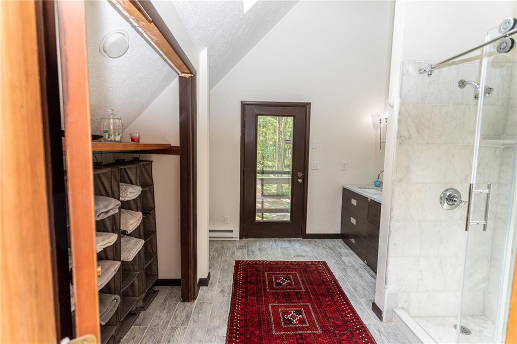 255 Smith School Road Farmington, PA 15437 - Photo 34 of 50 a view of a hallway with wooden floor and a bathroom