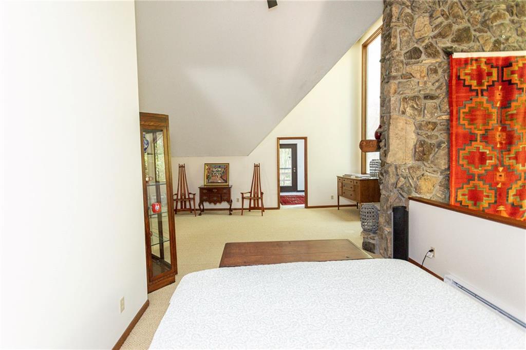 255 Smith School Road Farmington, PA 15437 - Photo 35 of 50 a bedroom with a bed and wooden floor