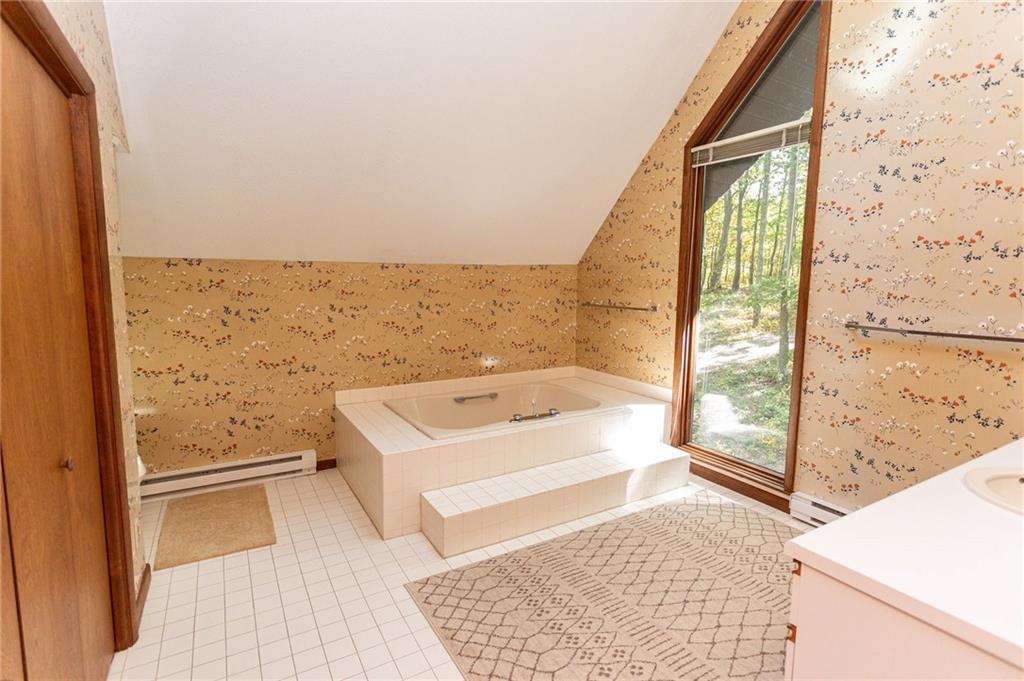 255 Smith School Road Farmington, PA 15437 - Photo 36 of 50 a bathroom with a bathtub and shower