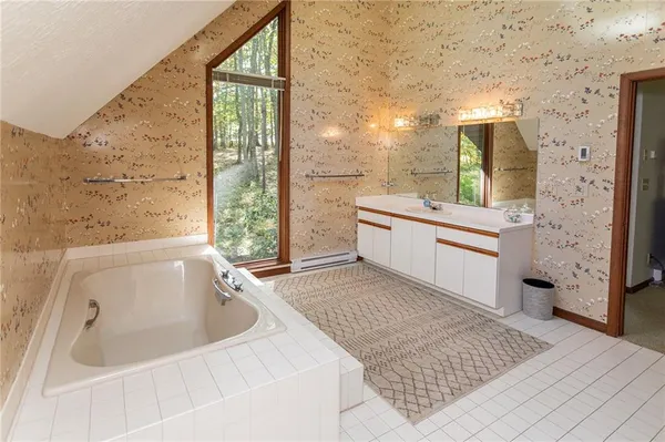 a bedroom with a bed and a fireplace