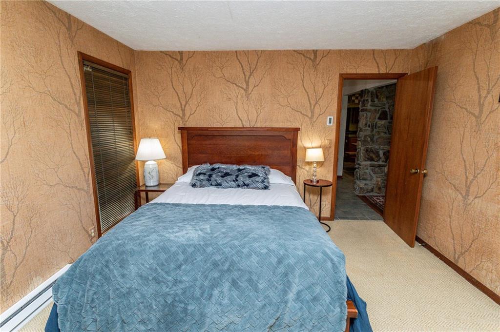 255 Smith School Road Farmington, PA 15437 - Photo 47 of 50 a bed room with a bed and a night stand