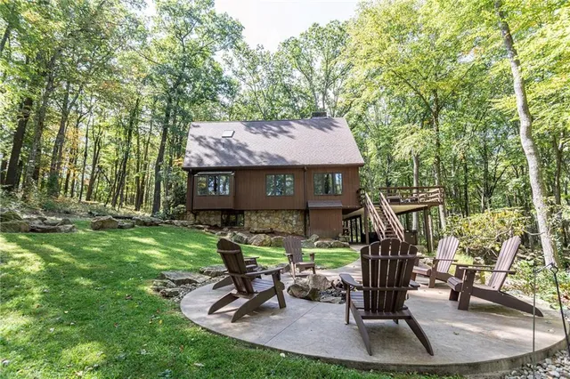 a view of a house with backyard porch and sitting area