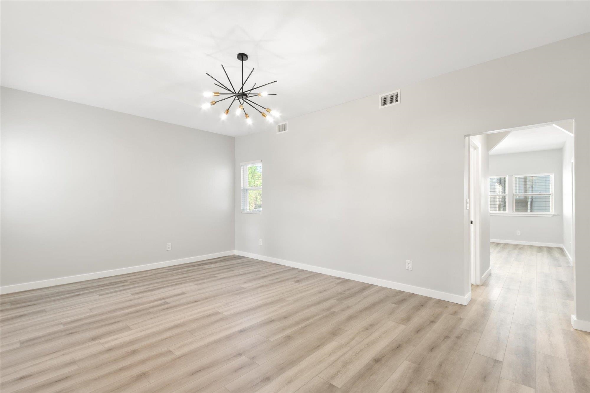 28 Sebastian Avenue, Unit A St. Augustine, FL 32084 - Photo 11 of 26 wooden floor in an empty room with a window