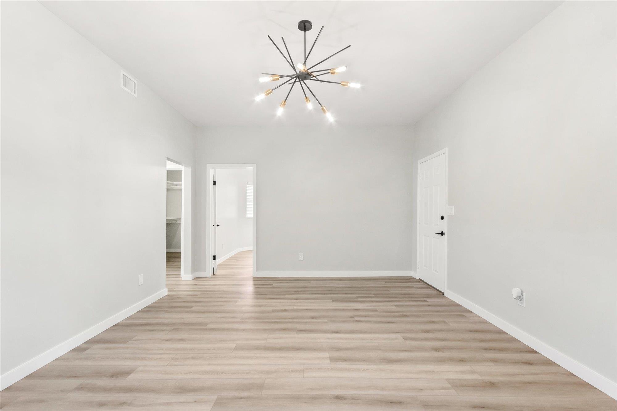 28 Sebastian Avenue, Unit A St. Augustine, FL 32084 - Photo 13 of 26 a view of an empty room with wooden floor and a ceiling fan