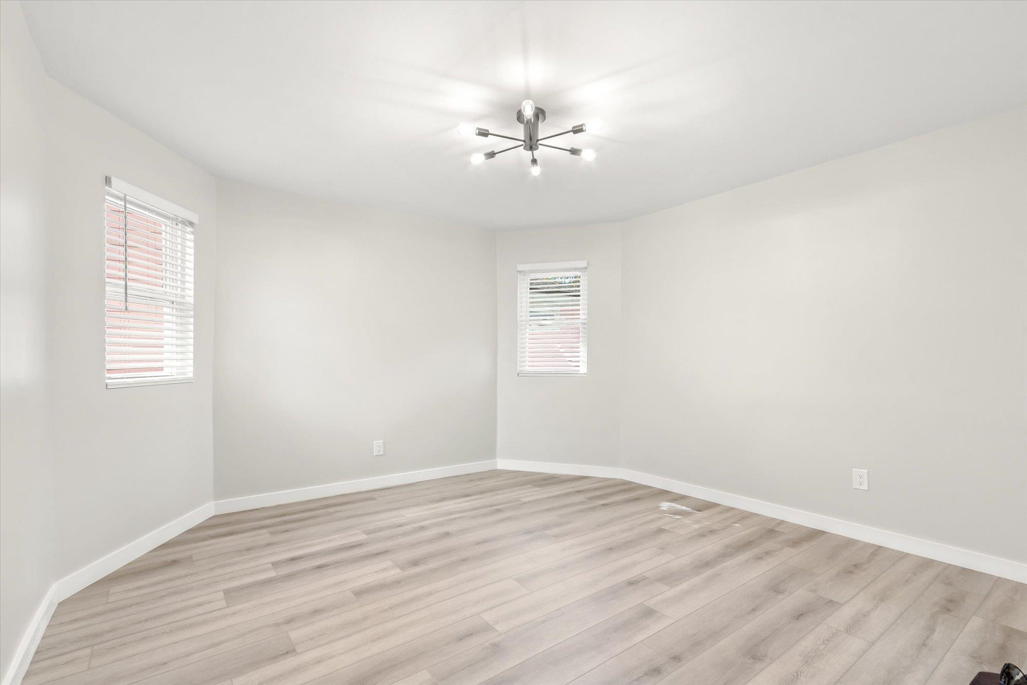 28 Sebastian Avenue, Unit A St. Augustine, FL 32084 - Photo 18 of 26 a view of an empty room with wooden floor and a window