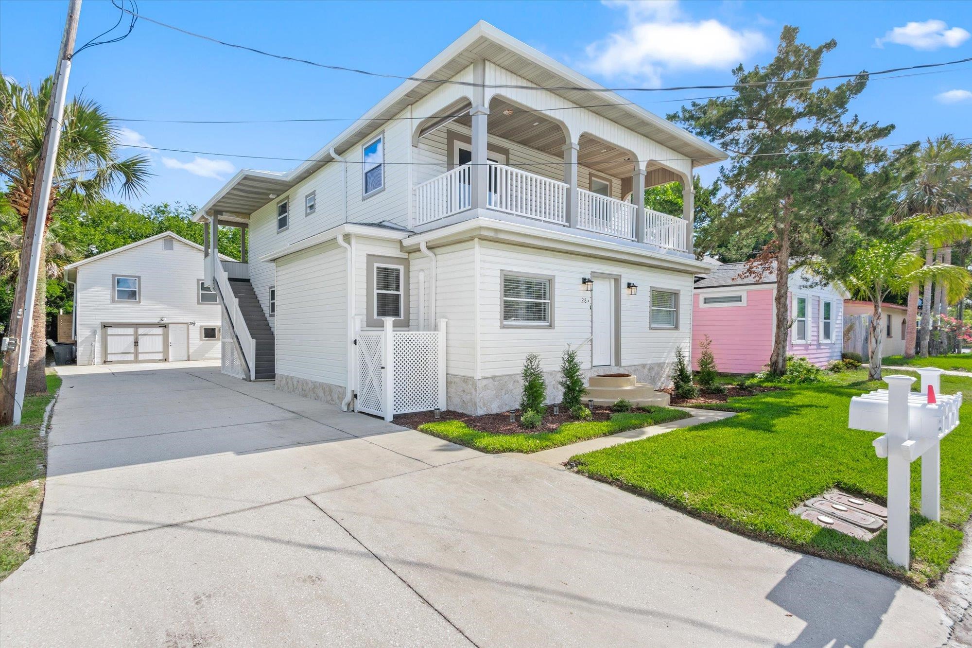 28 Sebastian Avenue, Unit A St. Augustine, FL 32084 - Photo 20 of 26 a front view of a house with garden and trees