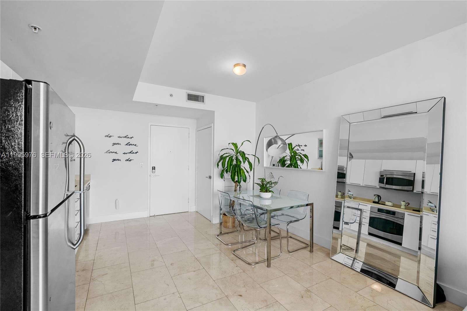 90 Southwest 3rd Street, Unit 1209 Miami, FL 33130 - Photo 11 of 33 a view of kitchen with furniture and refrigerator