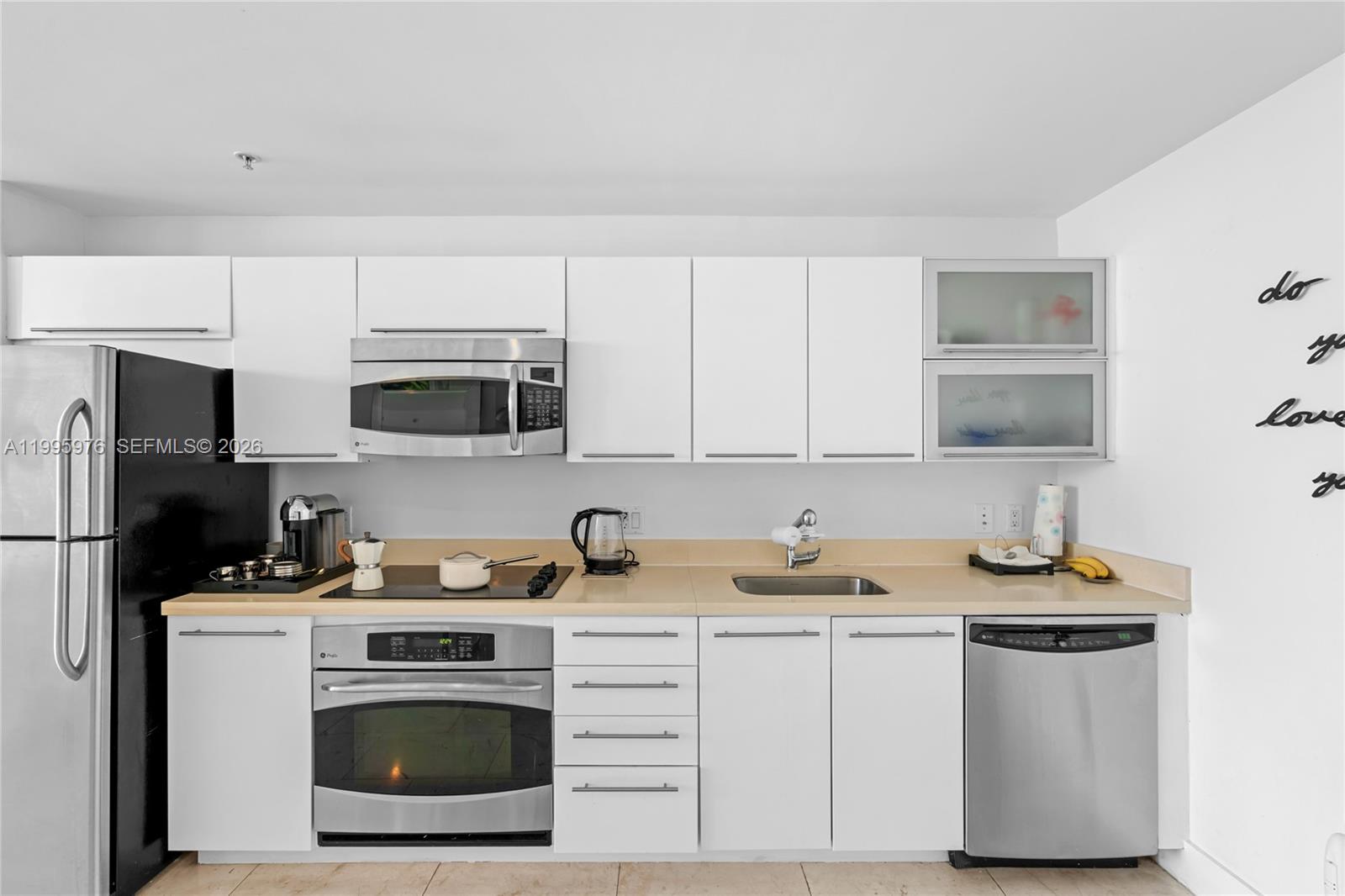 90 Southwest 3rd Street, Unit 1209 Miami, FL 33130 - Photo 14 of 33 a kitchen with stainless steel appliances granite countertop a sink stove and microwave