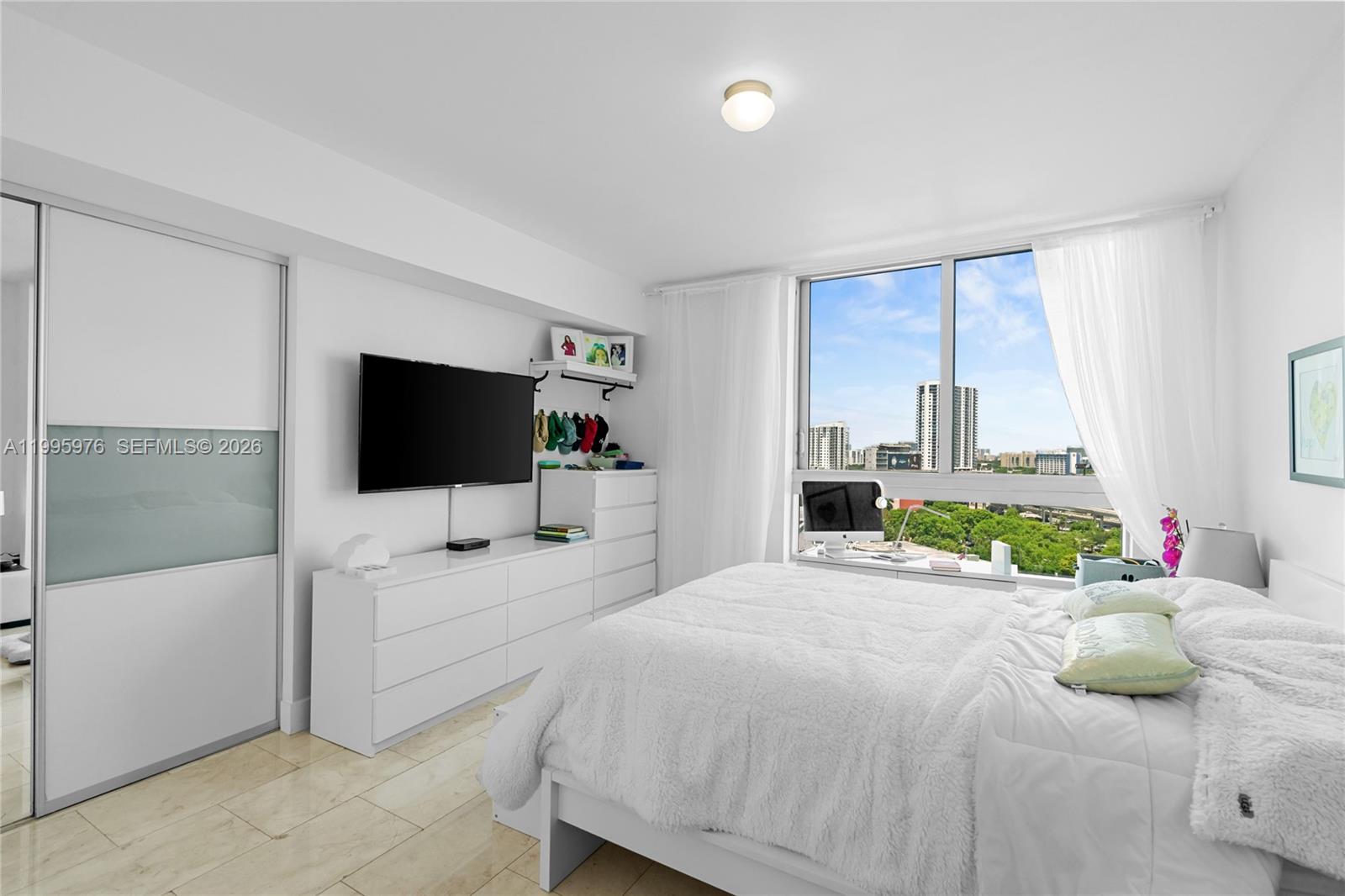 90 Southwest 3rd Street, Unit 1209 Miami, FL 33130 - Photo 18 of 33 a bedroom with a bed and a flat screen tv