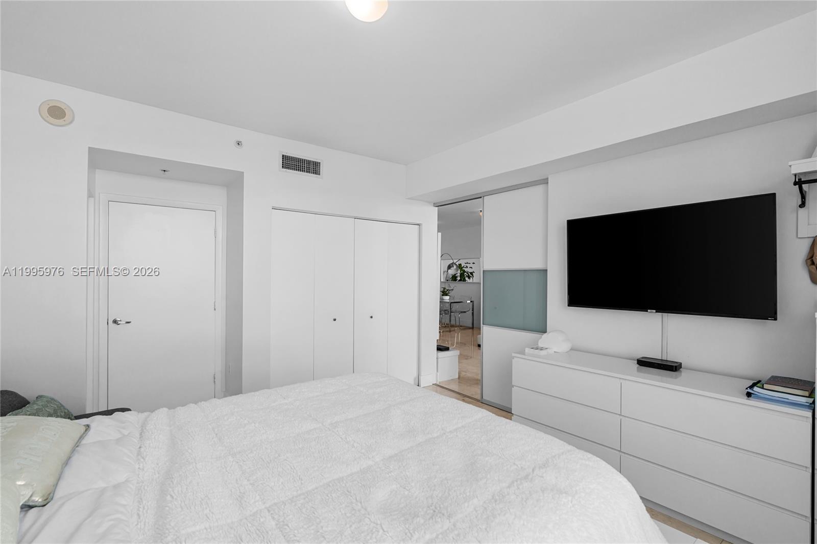 90 Southwest 3rd Street, Unit 1209 Miami, FL 33130 - Photo 20 of 33 a bedroom with a bed and a flat screen tv