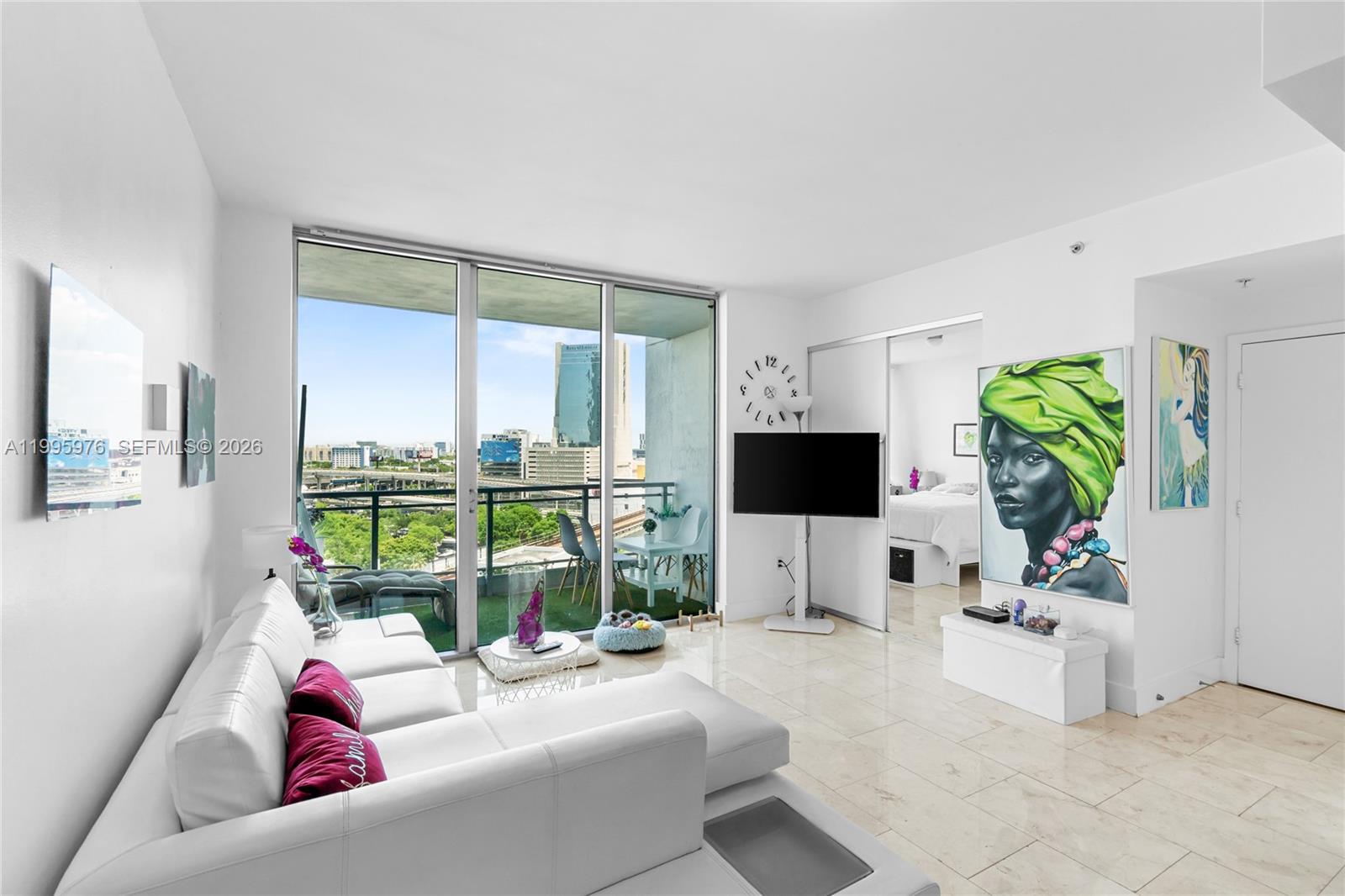 90 Southwest 3rd Street, Unit 1209 Miami, FL 33130 - Photo 2 of 33 a living room with furniture a large window and a flat screen tv