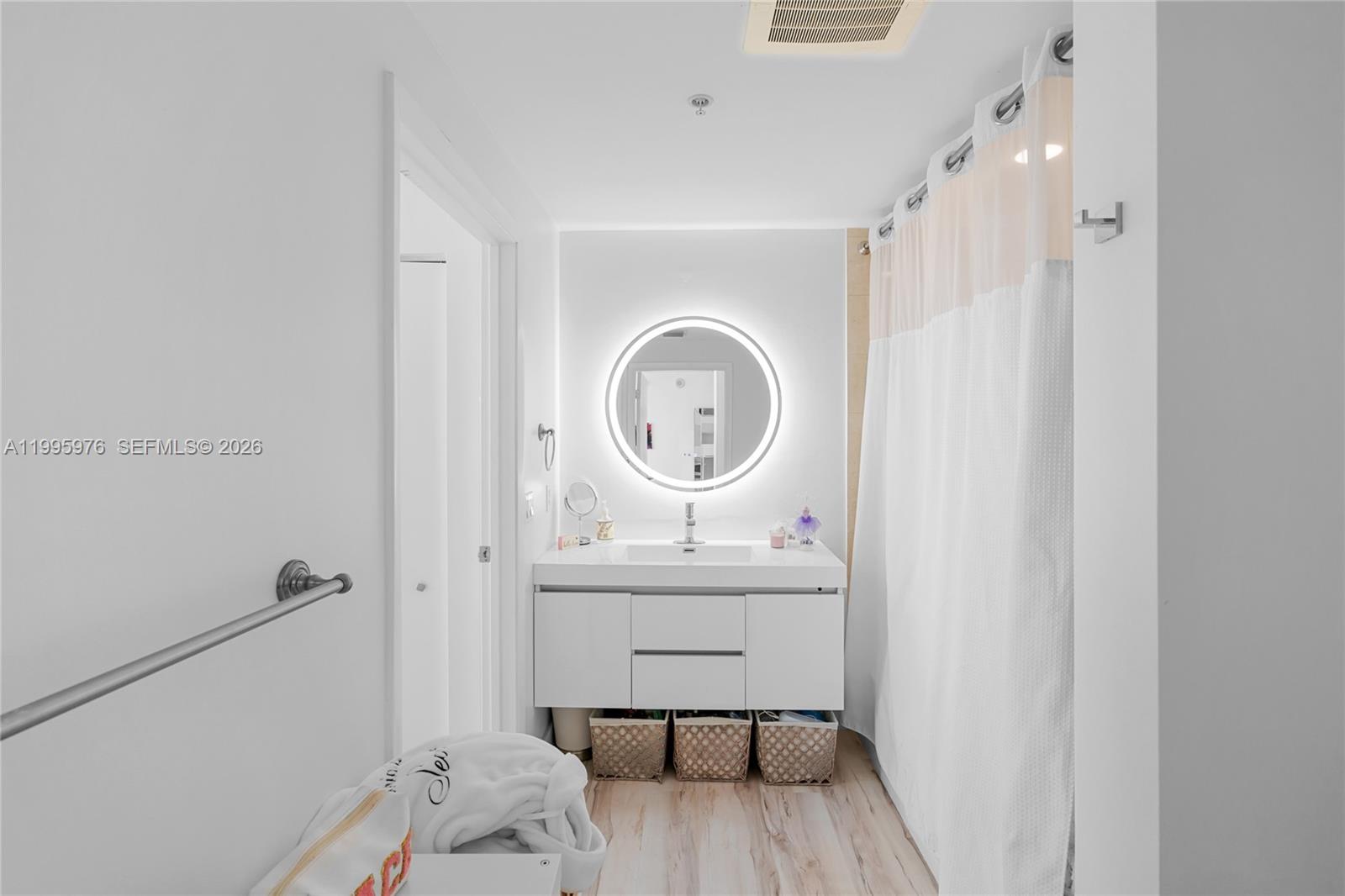 90 Southwest 3rd Street, Unit 1209 Miami, FL 33130 - Photo 22 of 33 a bathroom with a sink a mirror and a toilet
