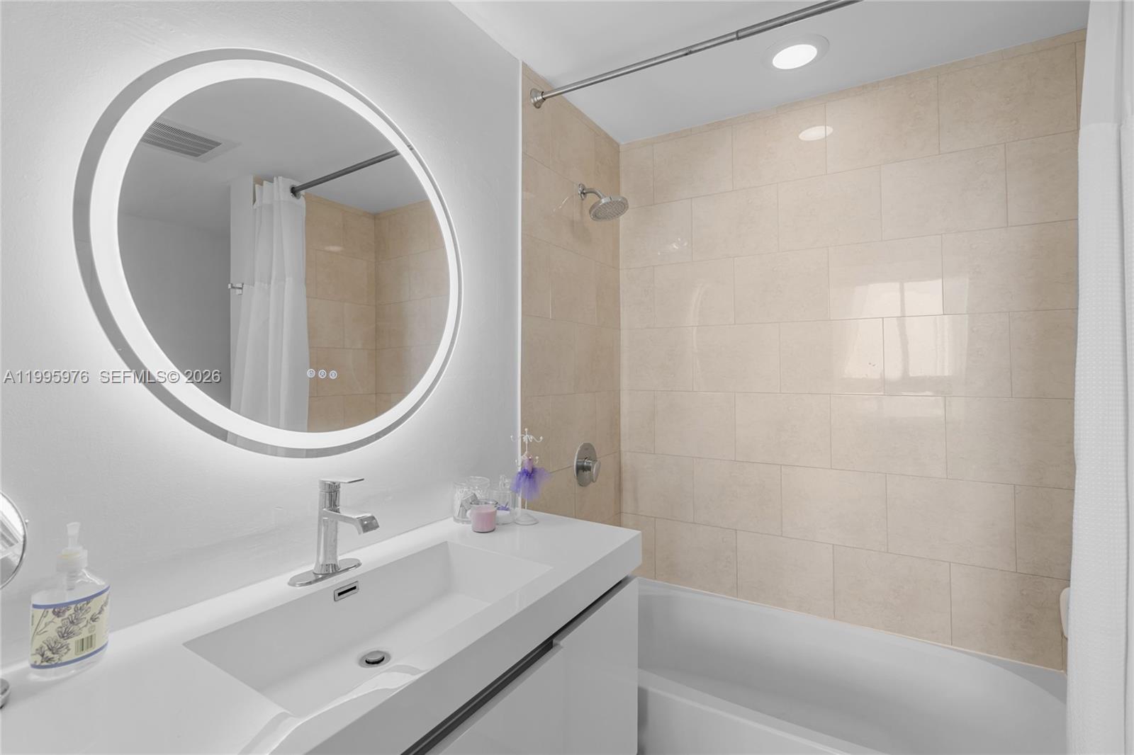 90 Southwest 3rd Street, Unit 1209 Miami, FL 33130 - Photo 23 of 33 a bathroom with a sink a toilet and a mirror