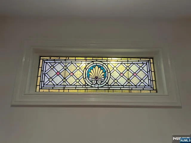 a view of a chair and table in backyard of the house